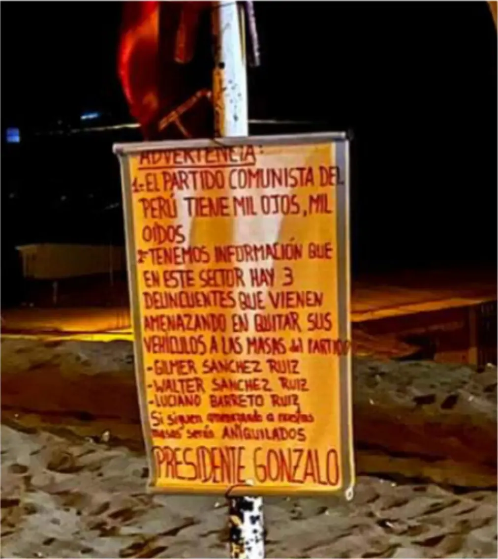 Sign that reads: 'WARNING: 1. THE COMMUNIST PARTY OF PERU HAS 1000 EYES AND 1000 EARS 2. WE HAVE INFORMATION THAT IN THIS SECTOR THERE ARE 3 DELINQUENTS THAT HAVE BEEN THREATENING TO STEAL VEHICLES FROM THE MASSES OF THE PARTY: GILMER SANCHEZ RUIZ, WALTER SANCHEZ RUIZ, LUCIANO BARRETO RUIZ. If they continue to threaten our masses, they will be ANNIHILATED. CHAIRMAN GONZALO', La Esperanza, Trujillo, 2023